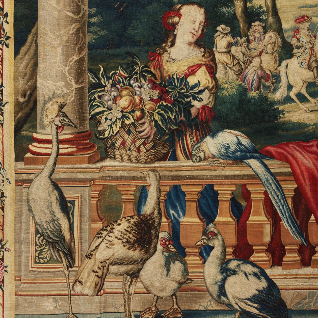 V_and_A's tweet image. This tapestry replica of ‘July’ from Charles Le Brun’s 1668 series shows Louis XIV hunting with courtiers amid symbols of power & wealth. Made by Jean de la Croix’s workshop, it adapts royal designs for elite clients, keeping the grandeur without gold threads.