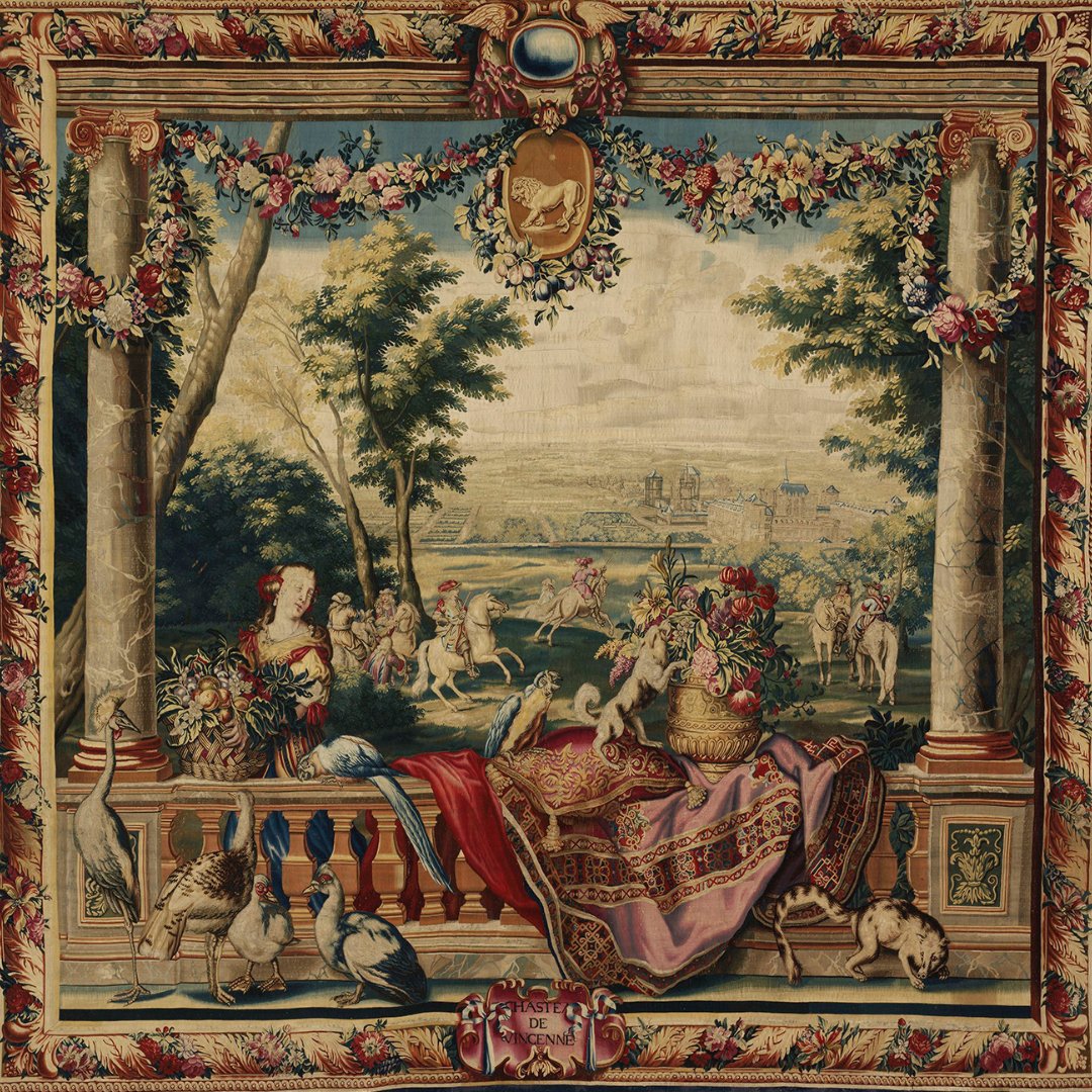 V_and_A's tweet image. This tapestry replica of ‘July’ from Charles Le Brun’s 1668 series shows Louis XIV hunting with courtiers amid symbols of power & wealth. Made by Jean de la Croix’s workshop, it adapts royal designs for elite clients, keeping the grandeur without gold threads.