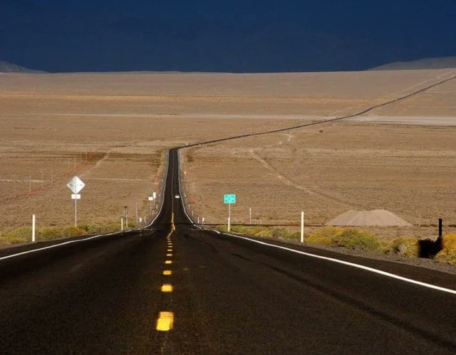 Highway 50 in Nevada -- "the Loneliest Highway"  --changed my life.

I hitchhiked the whole thing back in 2014. The desolation is incomparable. Nothing comes close. It's like an alien world even by Western standards.

Being there without a car, at the mercy of the piddling