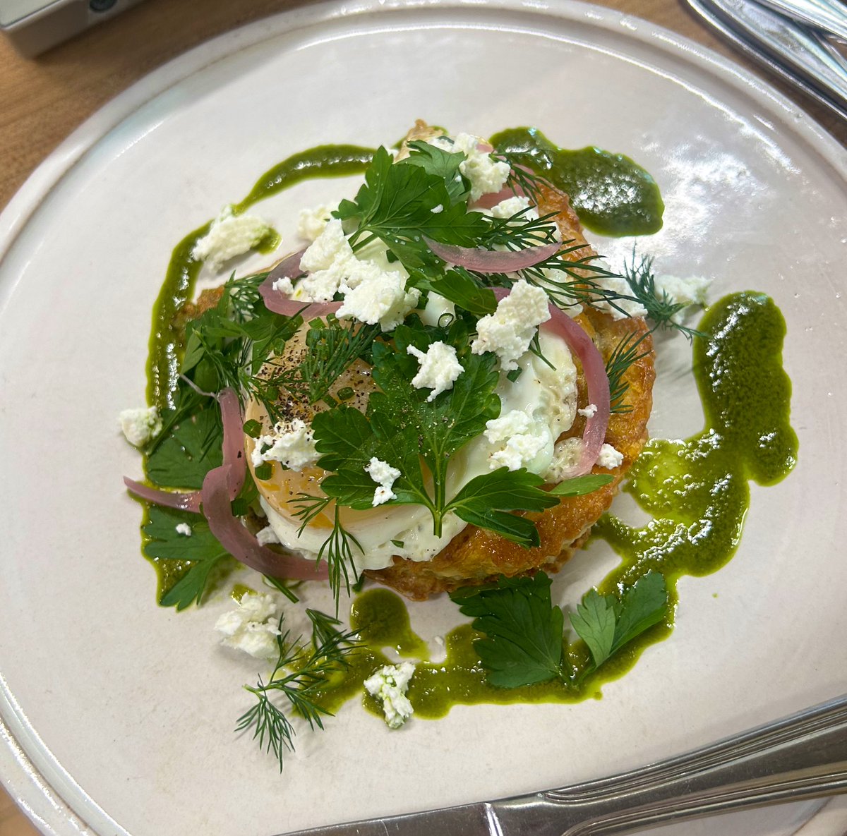 stuff1eee's tweet image. flaky ethiopian hand pie with stewed beef, collard greens, and lentils plated by my chef with smoked yogurt, a fried egg, green curry sauce, herbs and pickled onions.
