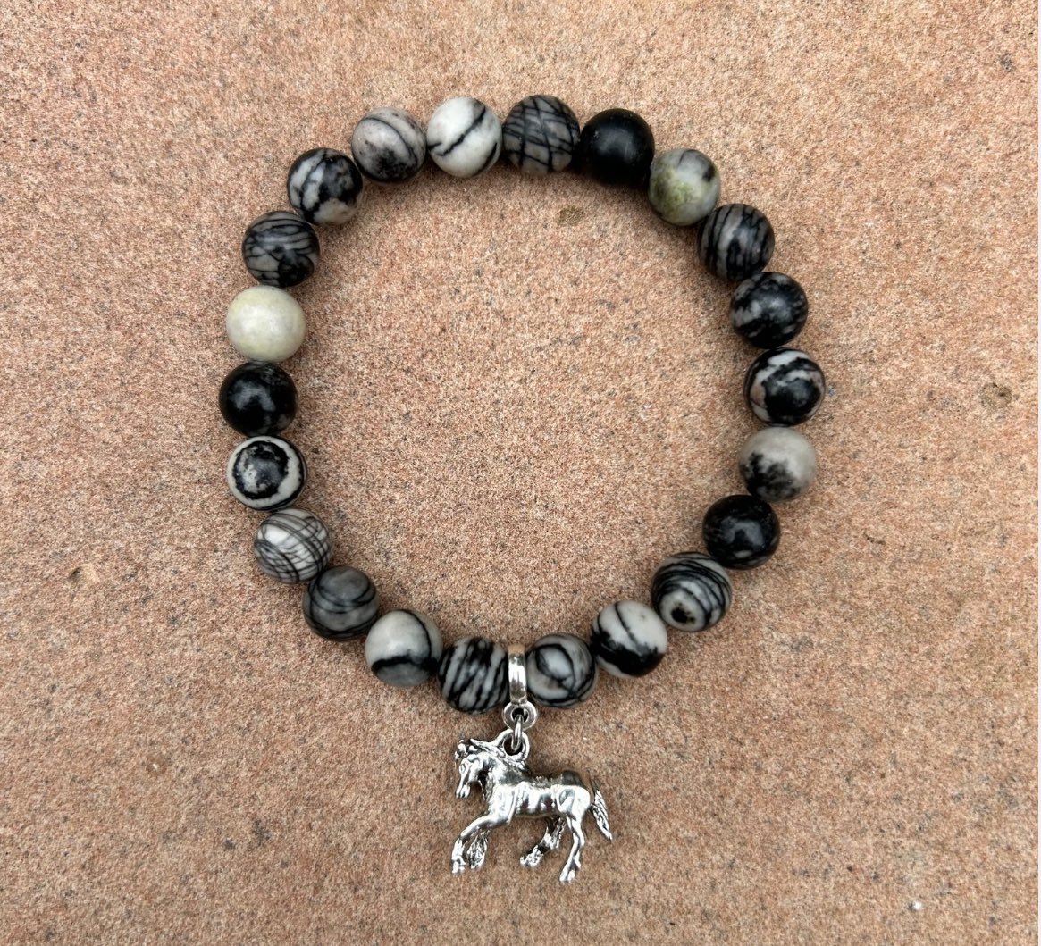Peggy Paarmann makes this beautiful #bracelet with beads &amp; a silver charm inspired by #bluezeus, the #wildhorse rescued by #skydogsanctuary. You support Skydog when you buy it from the store: skydogranch.org/skydog-store/b…