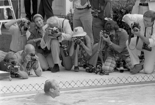 President Ford takes his first swim at the new White House pool. Reporters are on hand to document.