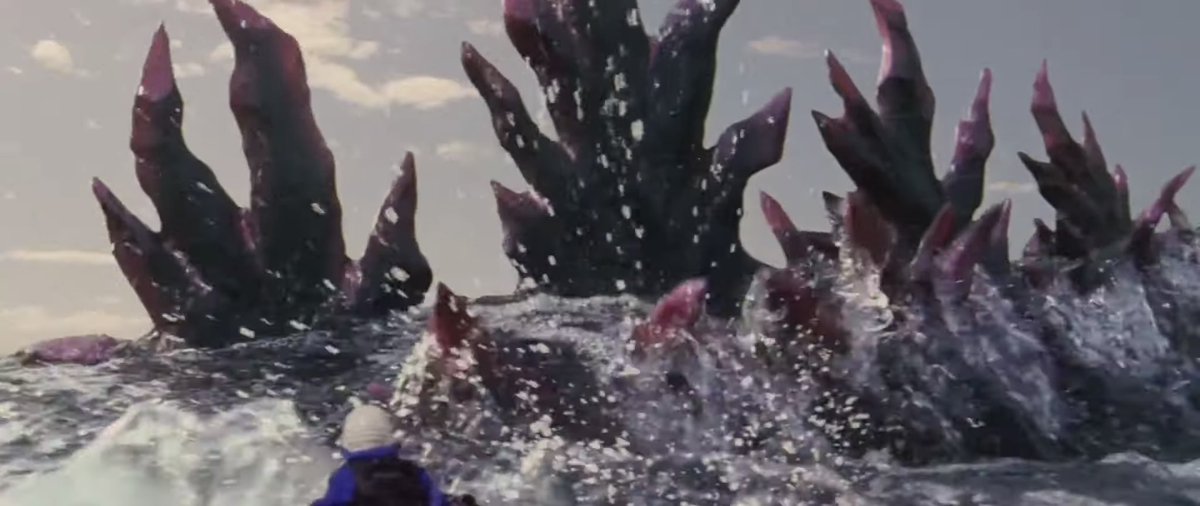 Godzilla’s dorsal plates sticking out of the water