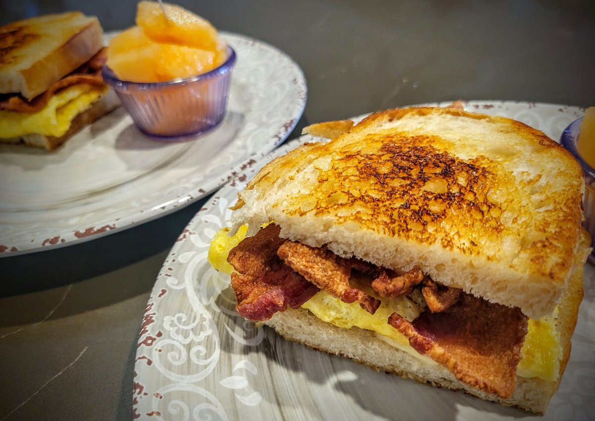 I made Mrs. J and I Bacon, Egg, Cheddar &amp; Greyeure Sourdough sandos with fresh Sugar-Kiss melon
