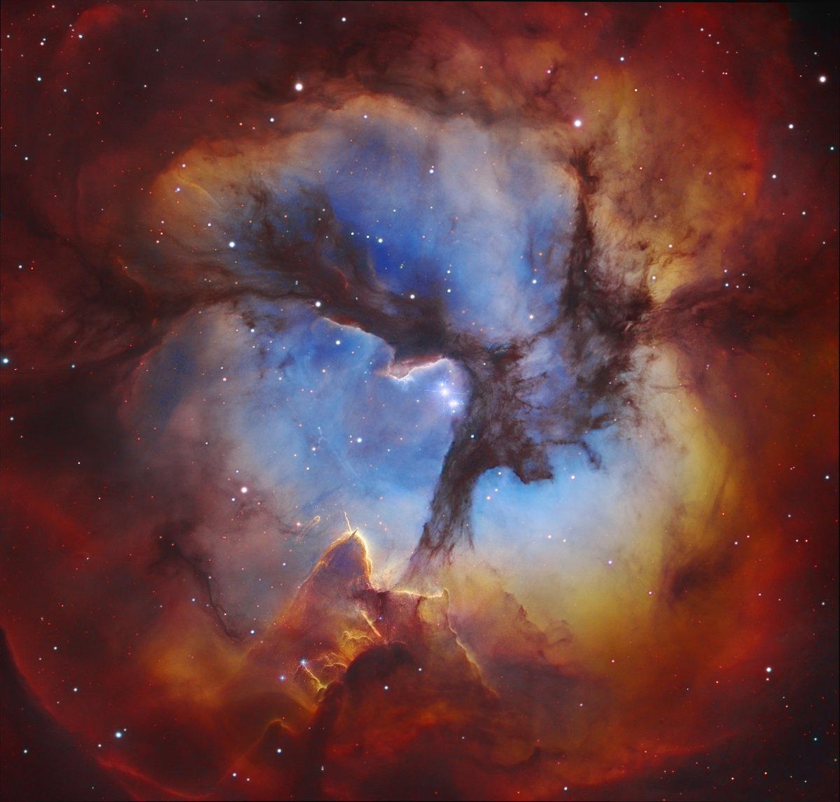 The Trifid Nebula (M20), located ~9,000 light-years away in the constellation Sagittarius, is a vibrant star-forming region just 300,000 years old.🌌✨

Its iconic three dark dust lanes converge near a glowing young star that illuminates this cosmic cradle