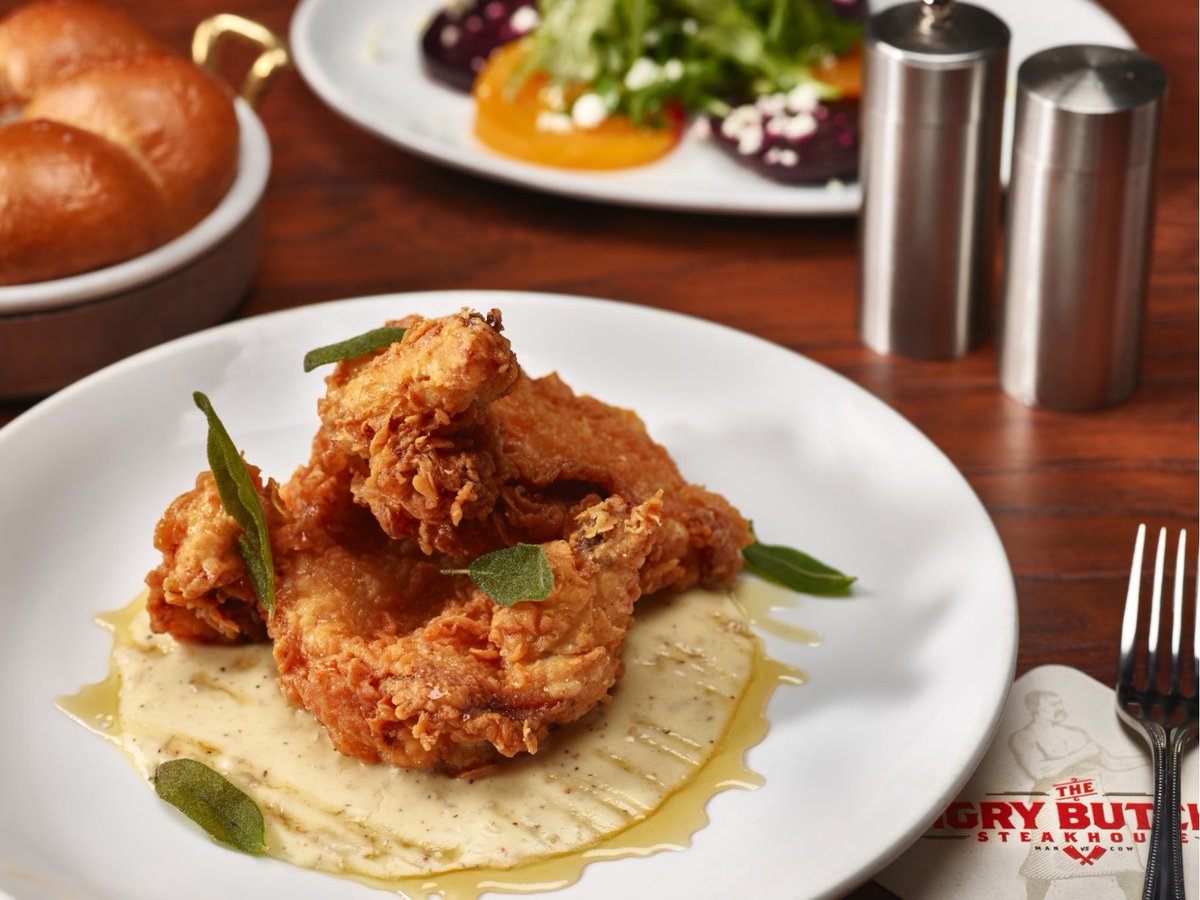 Crispy, flavorful, and downright delicious—celebrate National Fried Chicken Day at The Angry Butcher Steakhouse with our Buttermilk Fried Chicken Breast topped with sage &amp; sausage gravy! #NationalFriedChickenDay