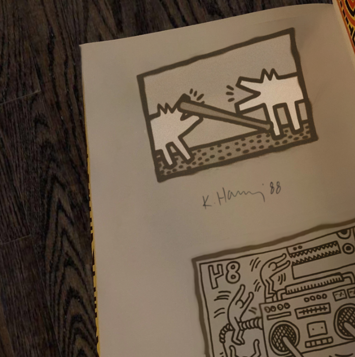 I just found the OG bonk meme. The Origin of Bonk meme comes from K. Haring's book.  

K. Haring never named the barking dogs so there is no name.