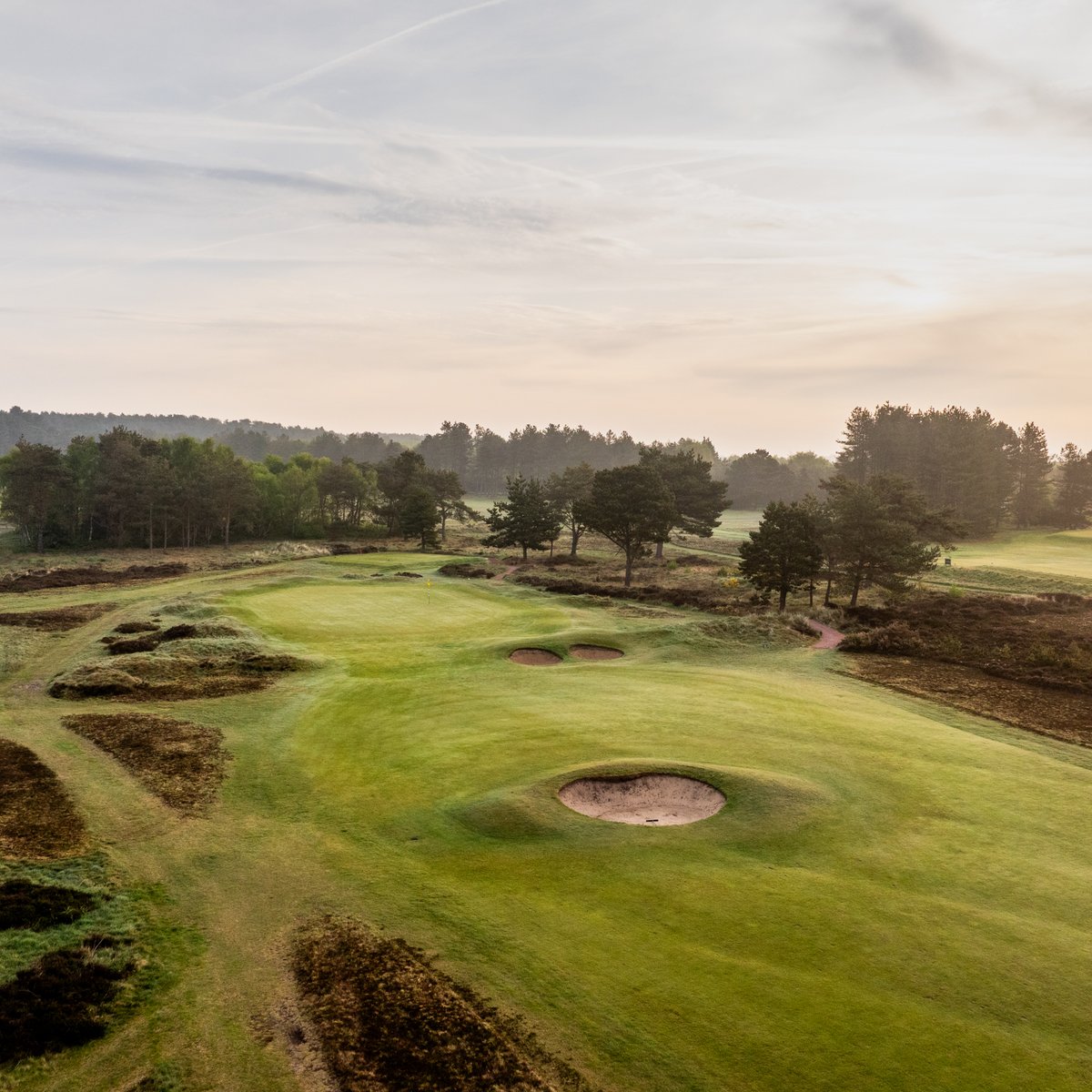 The par 5 2nd green is guarded by three perfectly placed bunkers that force the player to commit to their approach, whether running a long club along the ground or attempting to carry all the traps with a lofted club.