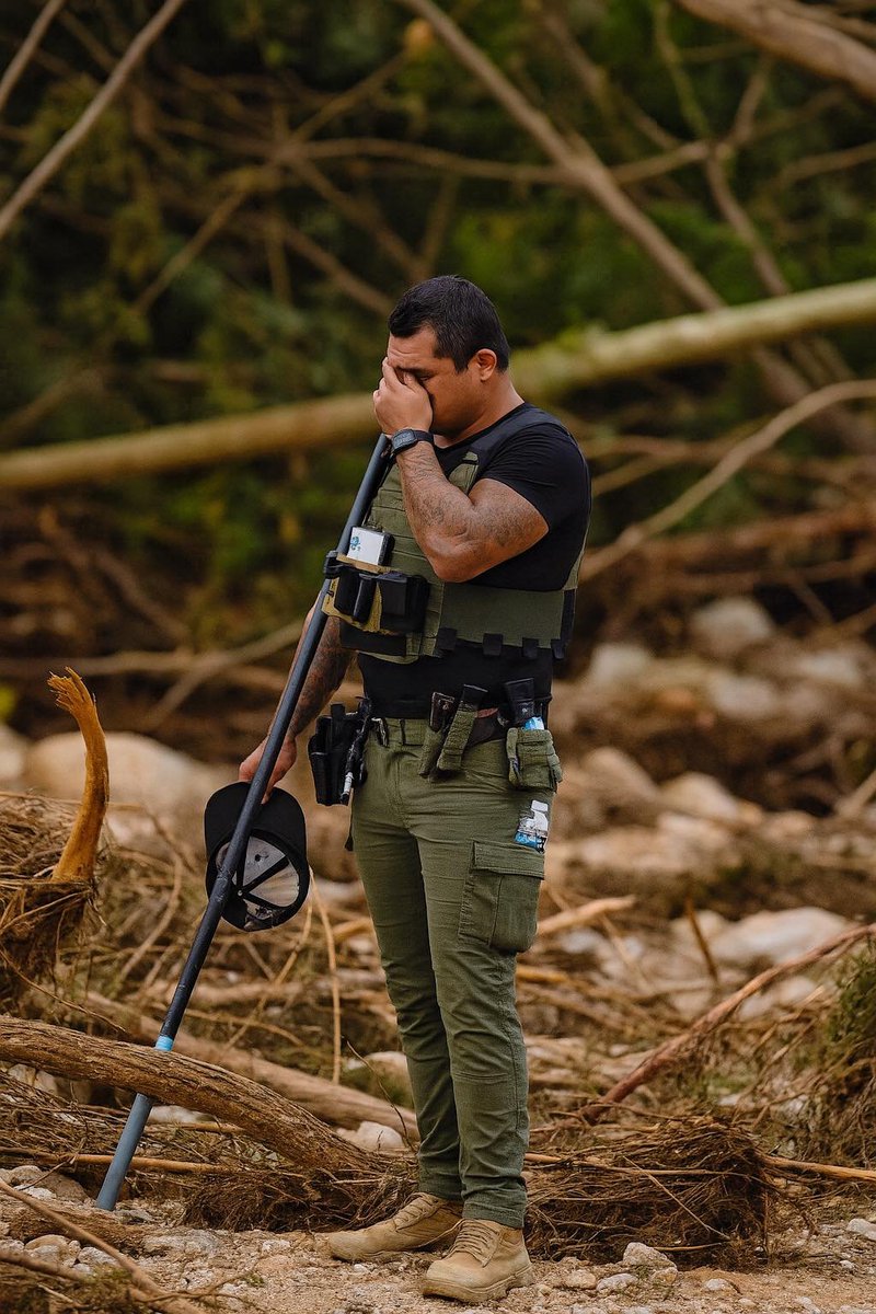 This dawn, an officer crumbled amidst the chaos; knee-deep in rubble, his heart crushed under the burden of what's still lost.

He’d been at it for hours, sifting through sludge, tangled roots, and raw grief, when the quiet screamed too loud. When the faces of those missing girls