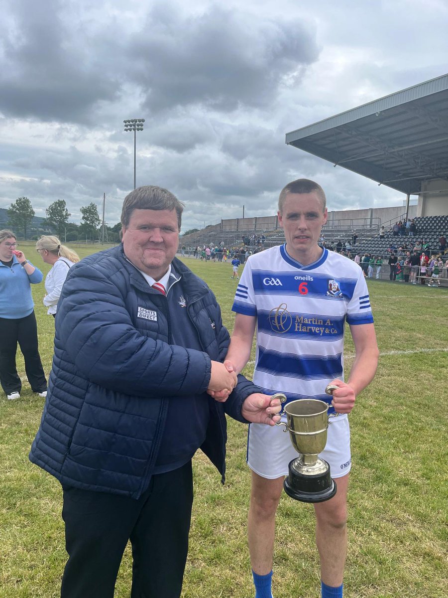 OfficialCorkGAA's tweet image. Ballyphehane captain Cian O’Brien receives the Cork County Confined Junior B Football Championship trophy from Derek Connolly of Cork County Board following his side’s victory over Araglen in Mallow today.