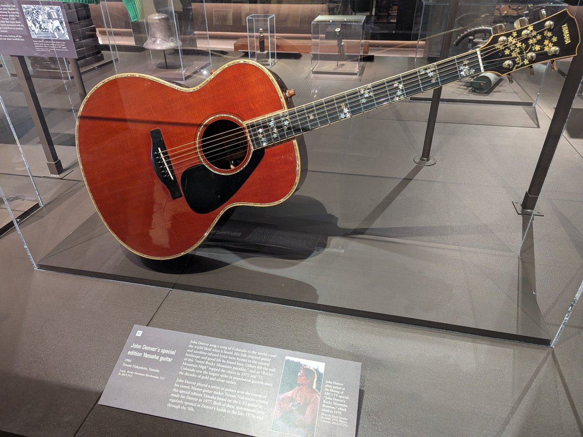 BrentHBaker's tweet image. Some fun things at History Colorado Center. John Denver's guitar, Bill Clinton's saxophone, noting Avalanche as 1996 Stanley Cup champions, home of the 1990s with an Iran-Contra/Oliver North Time mag.