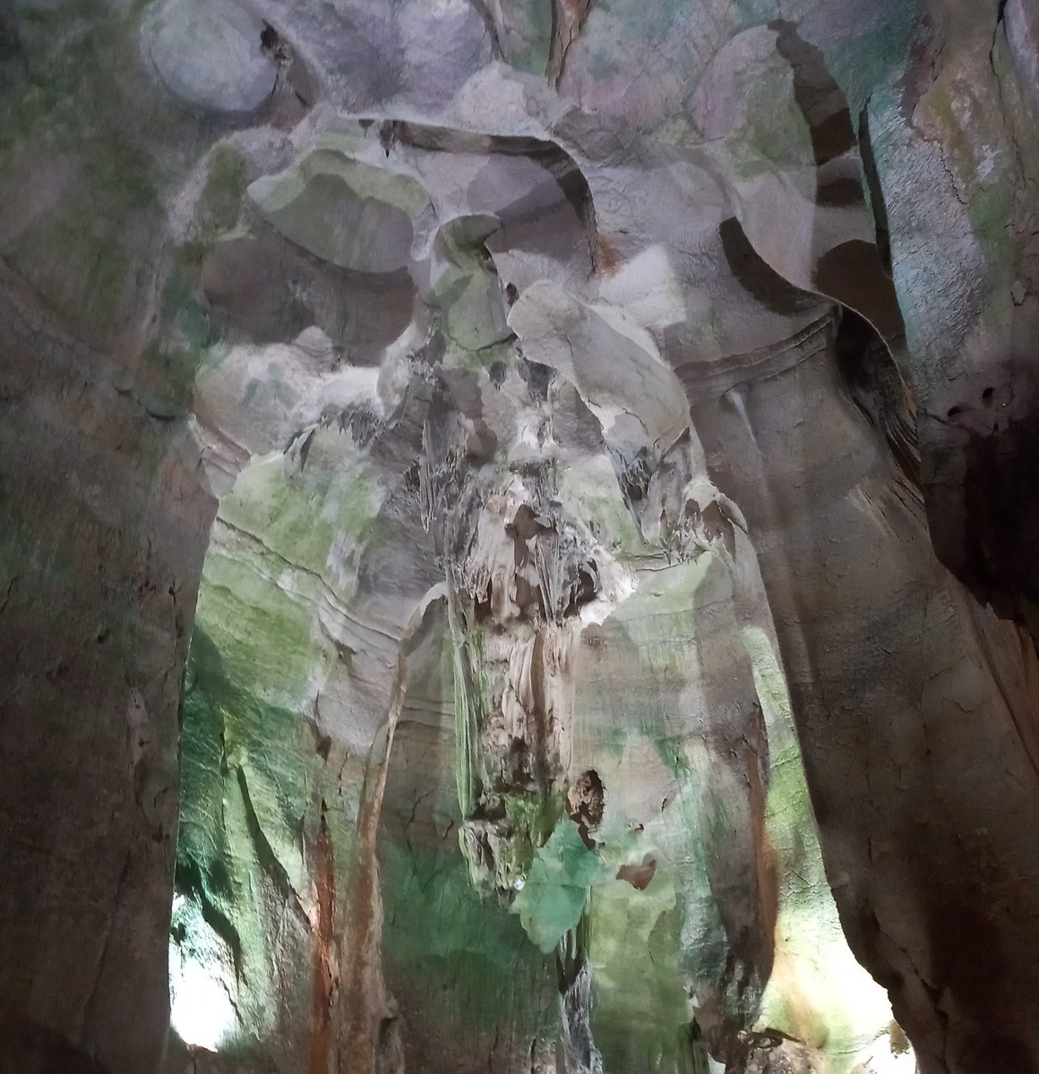 Can anyone else see a man in a green jacket shaking hands with someone...? I took this photo in the Cave of Skulls, Jalon Valley in Spain on Saturday
