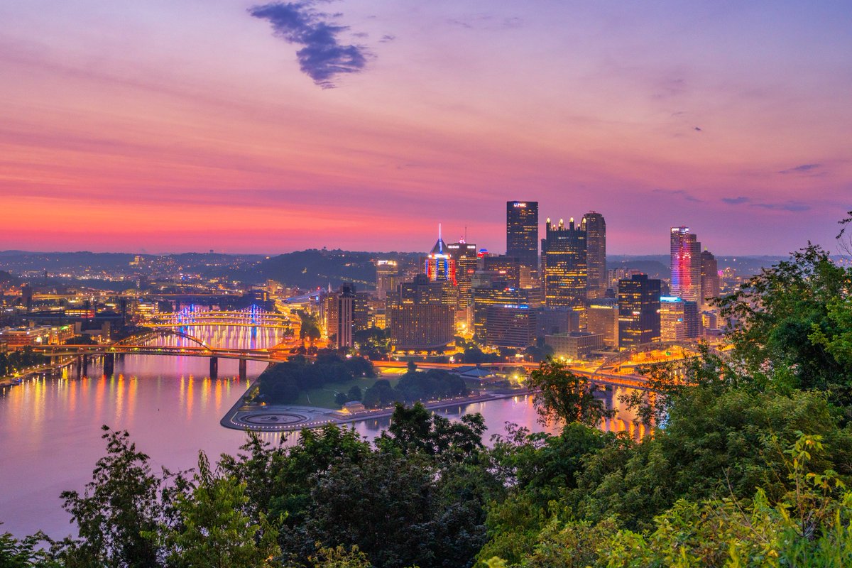 DaveDiCello's tweet image. Another view from the morning of July 4th in #Pittsburgh, this time from near the Point of View statue on the far end of Mt. Washington. I've always liked the combination of the trees on the hill and the city below, and the only thing missing from this view is the fountain.