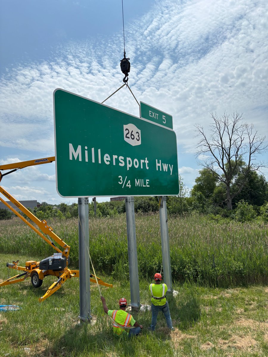 🚧DOT does more than just fix potholes (we do that too)! And every project has its challenges! Check out our crew using a crane 🏗️and teamwork to install a new sign on 990 near Millersport Highway in Amherst. #NYSDOT #Infrastructure