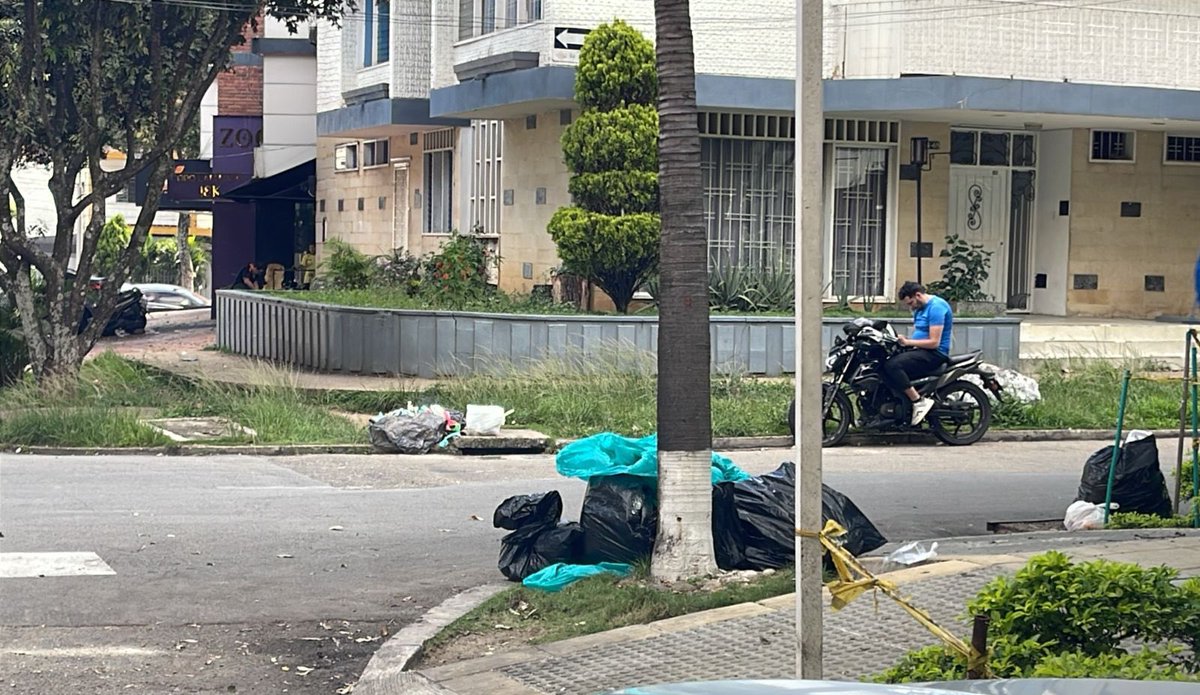 Los señores del restaurante Azafrán en la Calle 55 con Carrera 28 felices dejando la basura en la calle