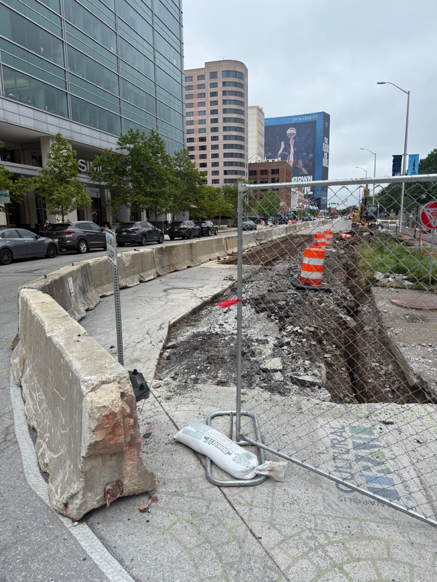 JATompkins's tweet photo. Old streetcar rails being dug up for the Blue Line are a reminder that Washington St has always been for transit and car-centricism was the aberration in our city’s history https://t.co/9IdvWSBn0N