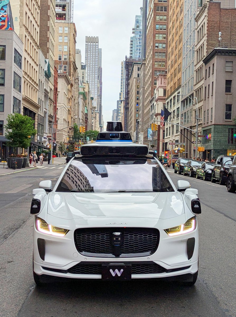 Waymo's tweet image. We're on the move in the Big Apple! 🏙️ We've begun testing in New York – be sure to give us a wave and snap a pic if you see us in the city.