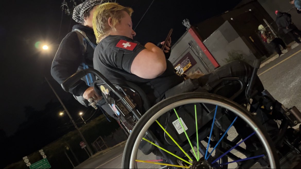 KatieDaviscourt's tweet image. I am growing suspicious of this wheelchair bound Portland Antifa militant featured in this video harassing federal officers outside the ICE facility.
I have captured this individual on several occasions standing up and walking around — she has some explaining to do.