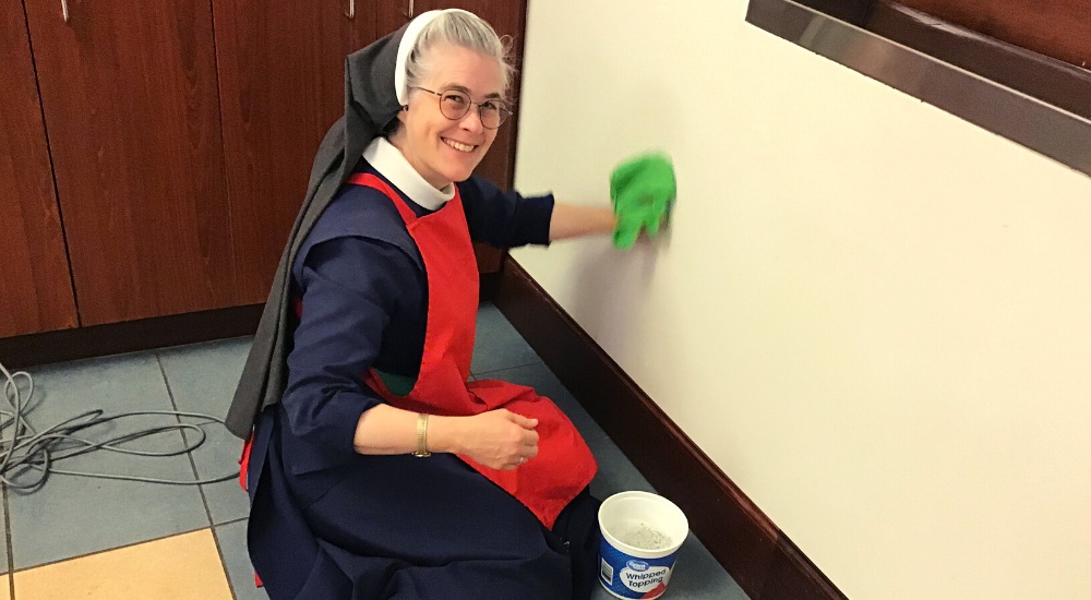 NunsHolding's tweet image. A Religious Sister of the Sisters of the Immaculate Heart of Mary of Wichita (IHM) in Colwich, Kansas cleaning a wall. Photo from the Sisters' website at sistersihmofwichita.org/community-life….