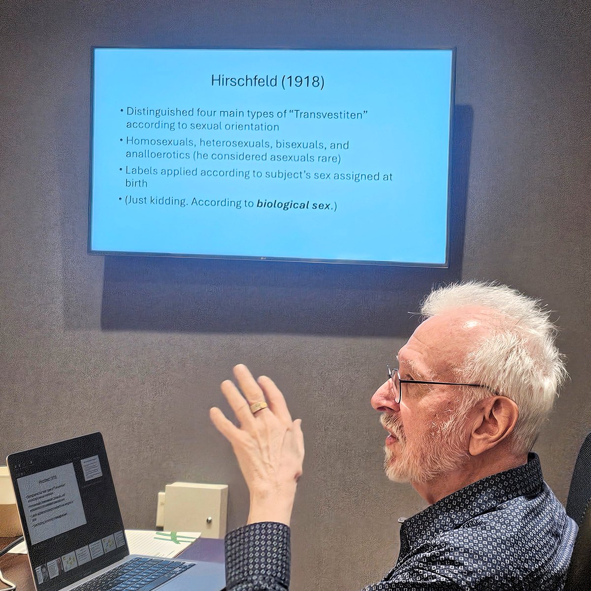 BlanchardPhD's tweet image. This is me presenting at a recent meeting of autogynephilia researchers, which was held in Toronto this past June. I just got access to photos taken in the meeting room.