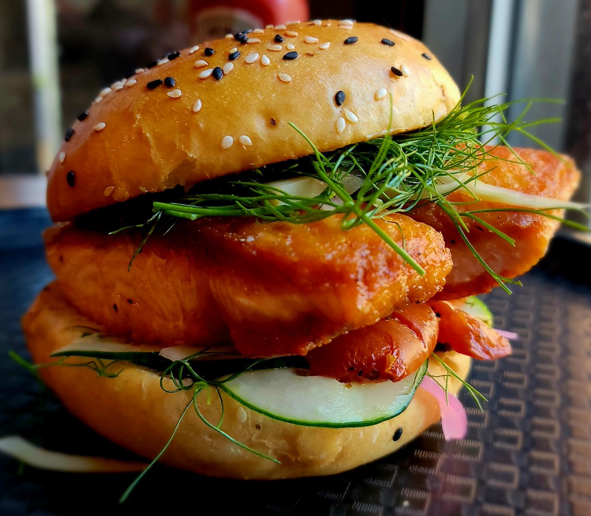 Block16Omaha's tweet image. Pan roasted line caught salmon finished in lemon and wine with charred fennel slaw, candied tomato, cucumber, pickled onion and citrus caper aioli on a sesame roll. Come see us!
