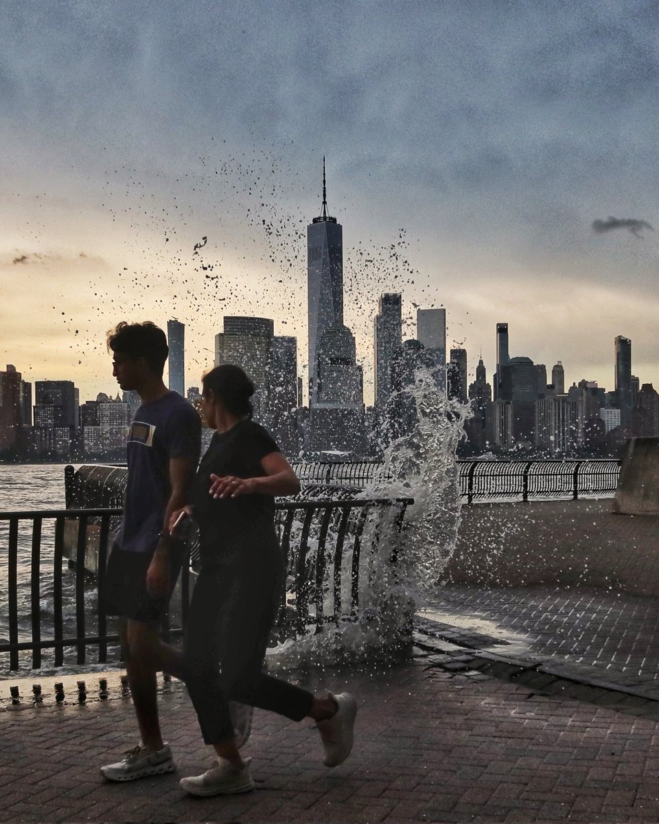 They almost got wet as the Hudson River splashes over a wall at high tide in Jersey City, NJ in front of One World Trade Center in New York City, Tuesday evening #newyorkcity #nyc #newyork