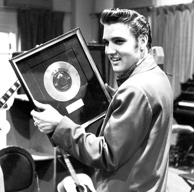 Elvis Presley with the one millionth “Heartbreak Hotel” record sold, 1956