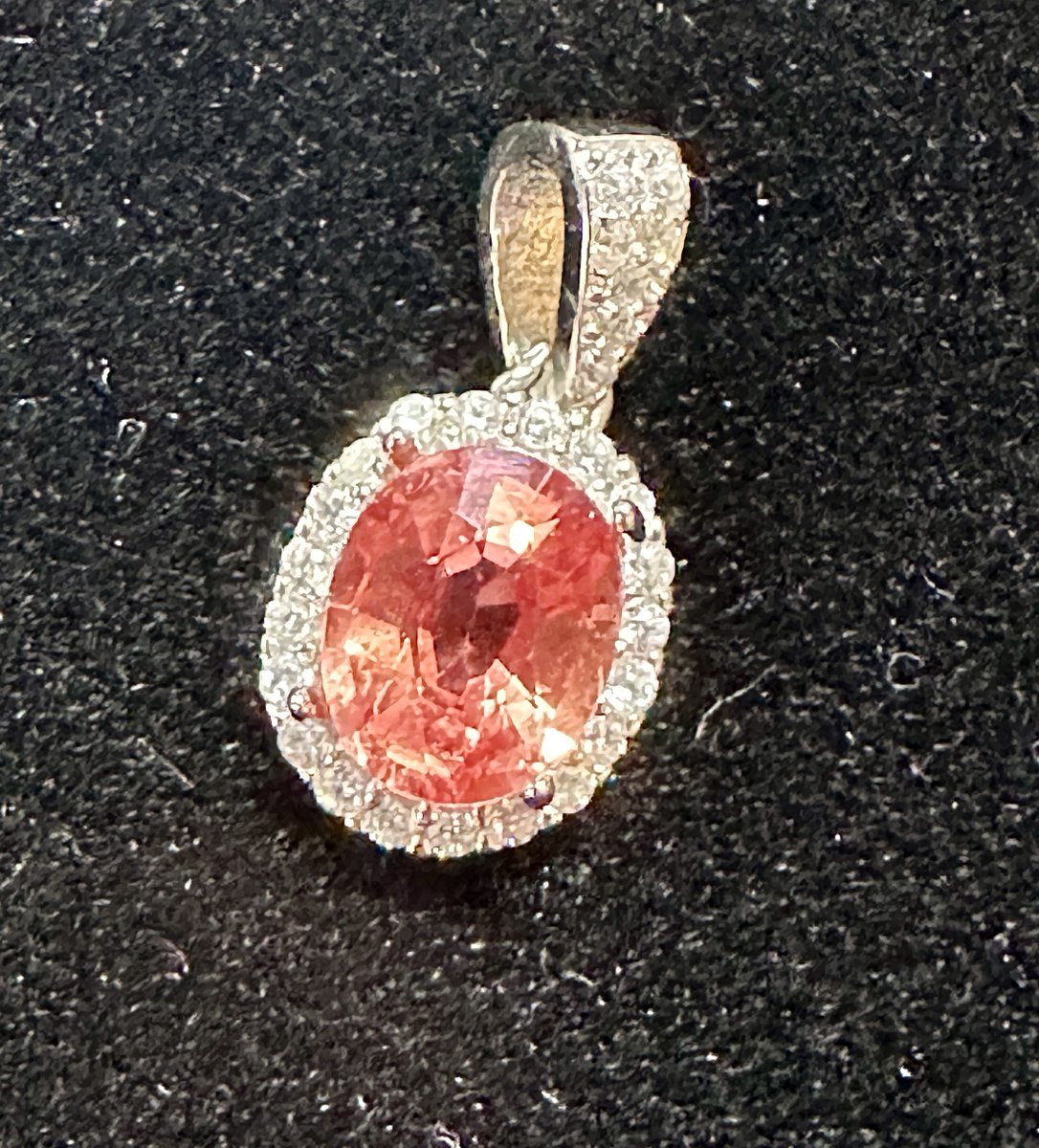 lindaw's tweet image. Sometimes we hold onto something not realizing the value. 20 years ago I came by this stone. It is a rare Padparadscha Sapphire.. slightly under 2 ct. eye clean. worth. $4,387 for a pretty rock, suround stones are white Topaz.