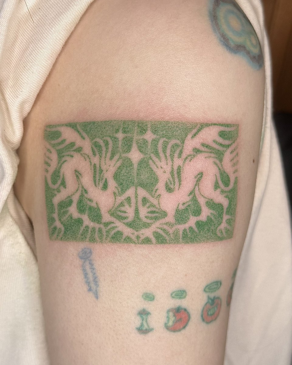 Handpoked green dragons