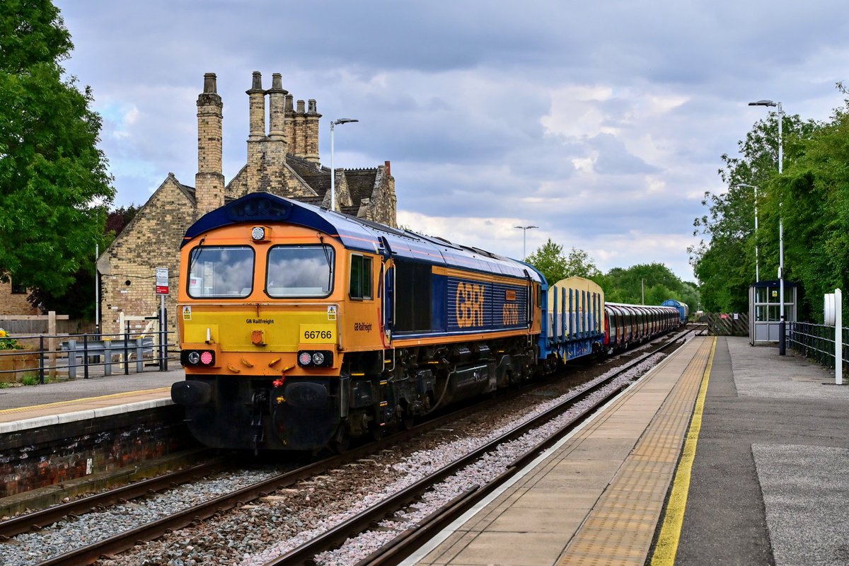 66735 leads through Saxilby with London Underground 24 Stock 38004 between some barrier vehicles and 66766 trailing on 6X21 Goole Siemens Factory to West Ruislip Lul Depot.