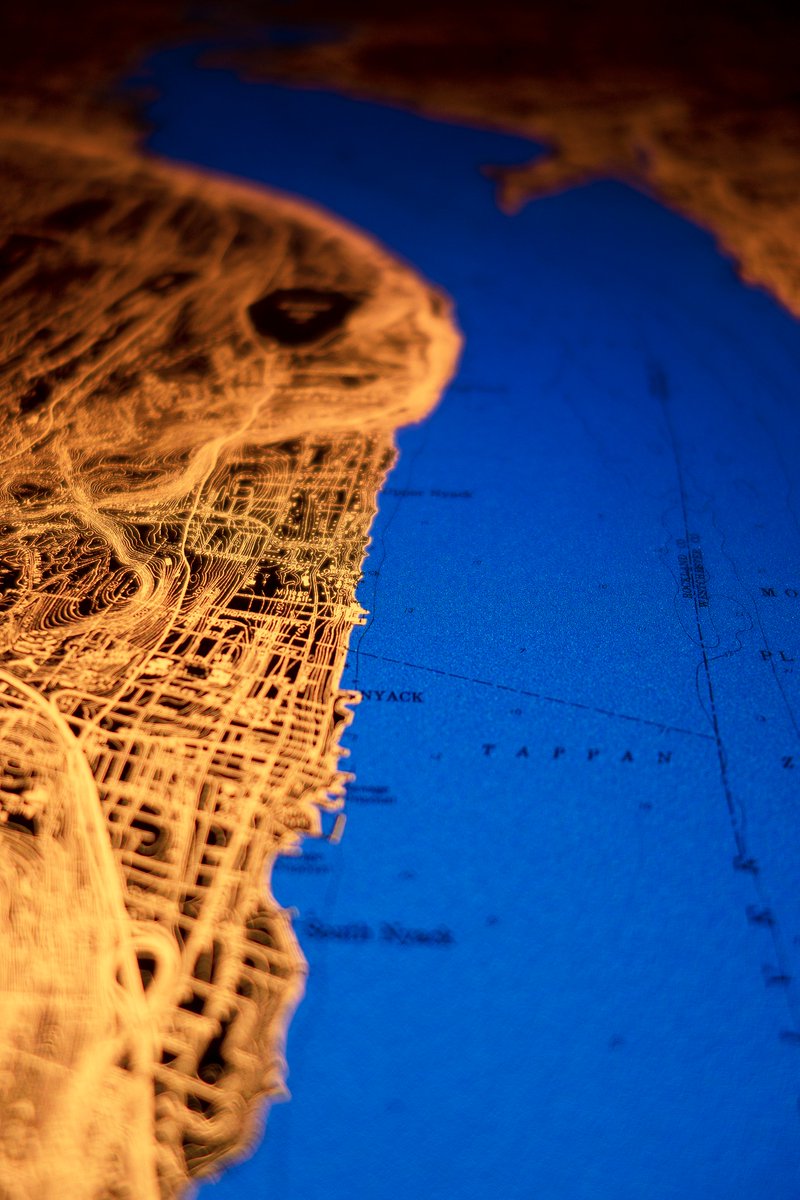 I need to make an acre-sized glowing map

Put it in a commercial building, a gallery, the town square in a muni expensive enough to repel bums