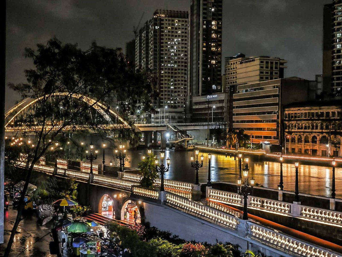 pnagovph's tweet photo. View of the Pasig River Esplanade by night, photographed from @Intramuros, Manila and with a view of Binondo District Tuesday (July 8, 2025). President Ferdinand R. Marcos Jr. has vowed to revive historic districts along the Pasig River. The esplanade will be about 25 kilometers long and will include Mandaluyong, Makati, Pasig and Taguig. (PNA photos by Joan Bondoc)