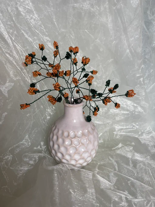 made some flowers out of beads and yarn