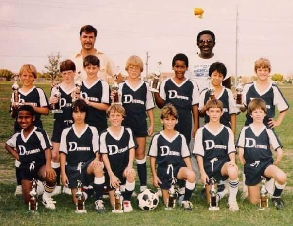 Michaelcx's tweet photo. @neenareports I grew up in a town that had sirens (shown in the background of my team picture), and we happily did drills once a month when the sirens were tested.

When I read that the area didn’t have sirens and the campsites had strict “no cell phone” policies, I was shocked. https://t.co/IG1jjf5qvG