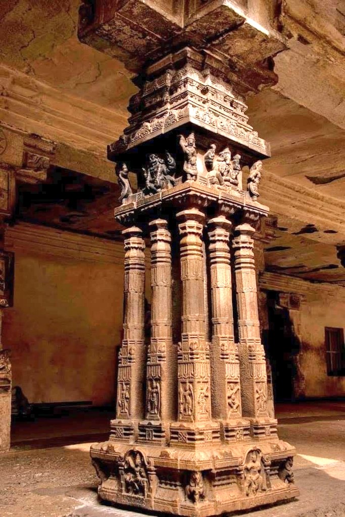 The image depicts an intricately carved pillar inside the Virupaksha Temple in Hampi, India.