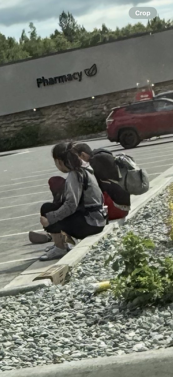 Homeless in Anchorage: baby strapped on the front of her while her and the dude smoking a blunt doing drugs in public. How tf is this child still with her? 🤬