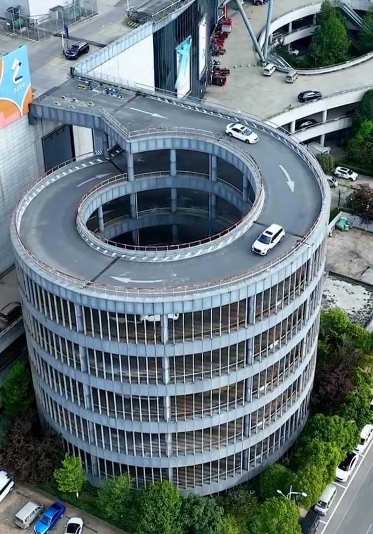 civil_works250's tweet photo. "This isn’t a racetrack — it’s a parking garage! 🚗😲
Engineering meets elegance in this mind-blowing spiral design.
Would you dare to drive down?👇
#Architecture #EngineeringMarvel #UrbanDesign #FuturisticCities #DriveGoals" https://t.co/KpqraOfxpT