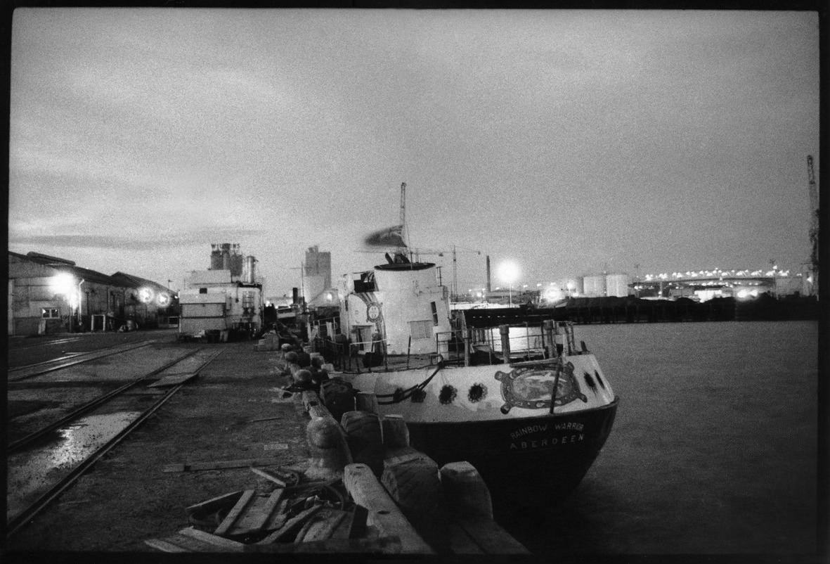 Forty years today since L'Affaire Greenpeace began. This was taken a year later, of the refloated but derelict Rainbow Warrior tied up at North Wharf. The ship is now 27 meters underwater at Matauri Bay. The sheds on the left are now bars and restaurants.
