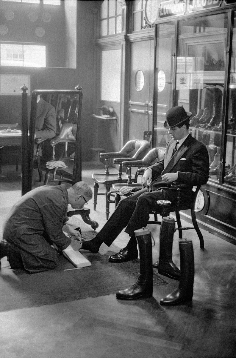 HistoryGirlBW's tweet image. A gentleman at Lobb’s shoe shop has his feet measured with precision for bespoke boots. London, 1959.