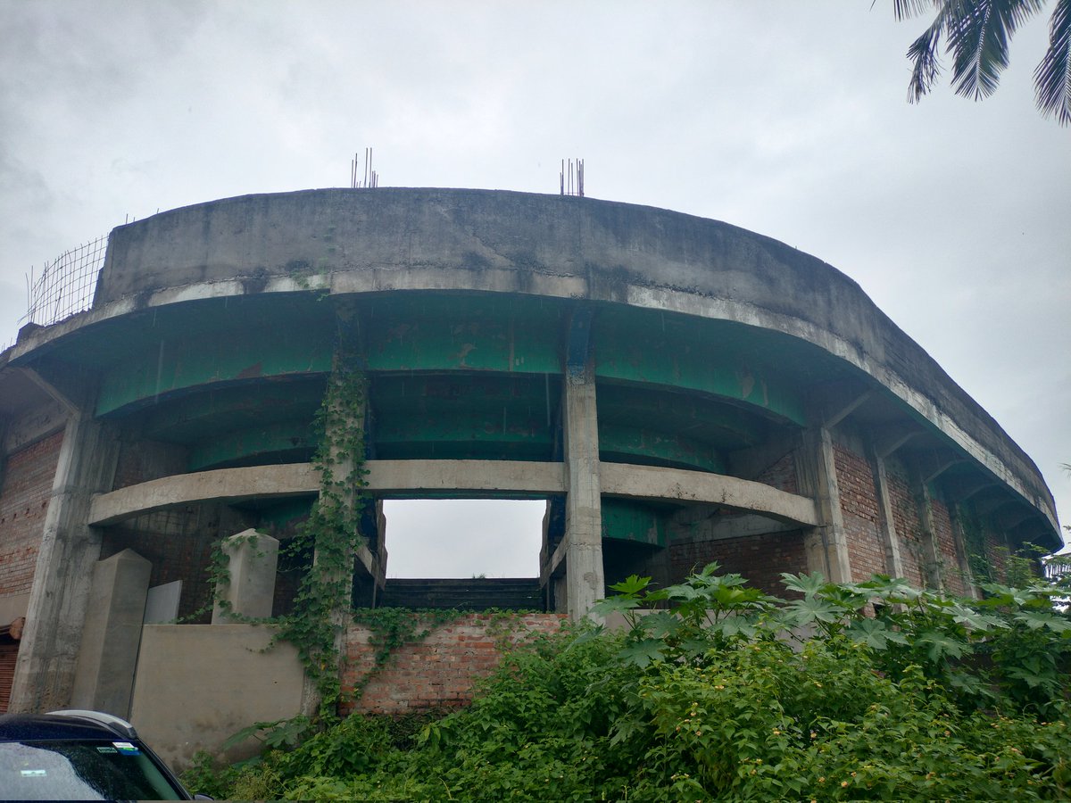 Abandoned Indoor Stadium project, Chandannagore.

No one is clear when the project was abandoned. The energy inside was disquieting, but I could imagine the stadium filled on Friday nights with shouts from the spectators.

A beauty nonetheless. I hope someone takes up restoration