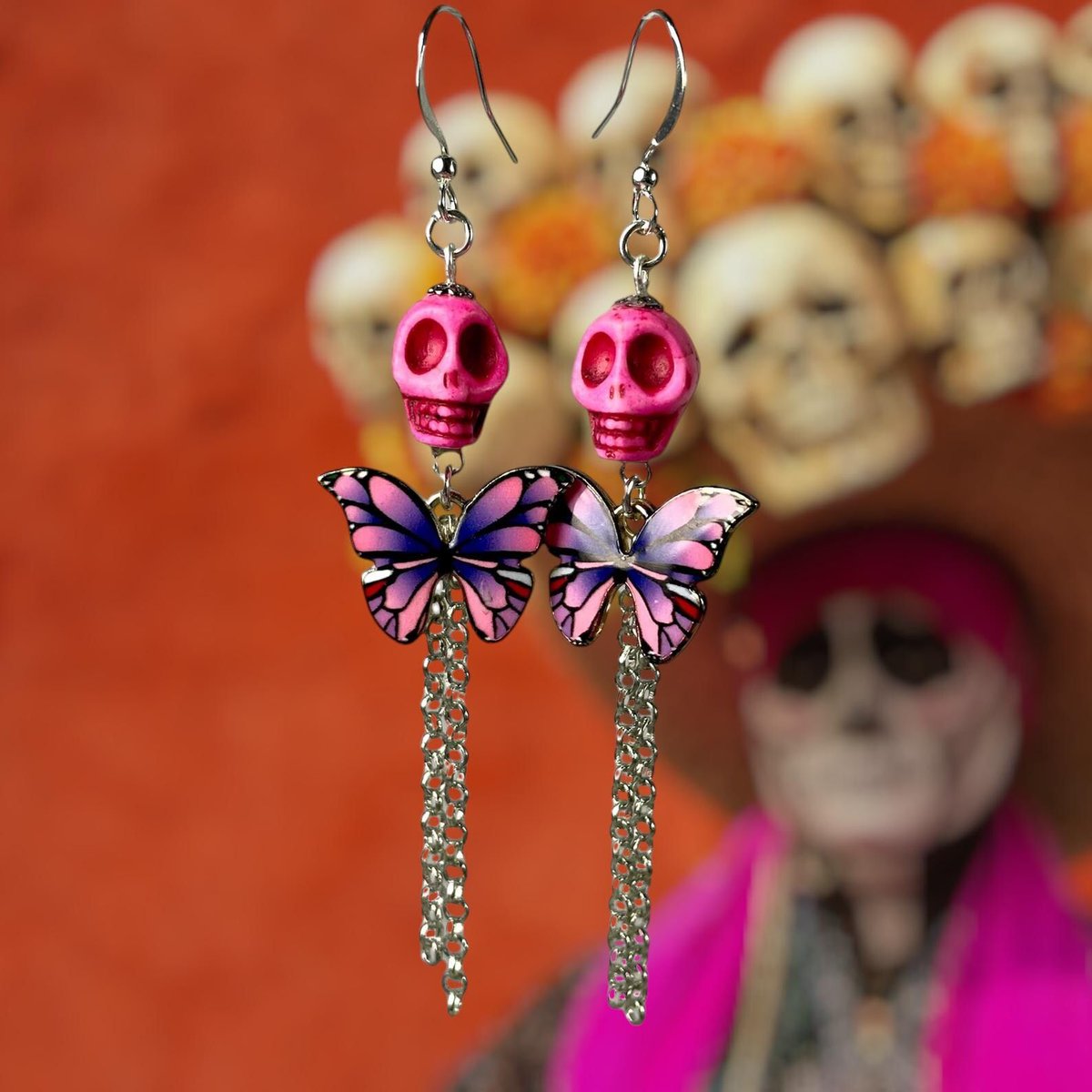 💀🦋 Sweet meets spooky! These pink &amp; purple butterfly skull earrings are the perfect blend of bold + beautiful. Celebrate Day of the Dead in style — now on sale! 👉 buff.ly/INdt1xP #diadelosmuertos #sugarskull #altstyle