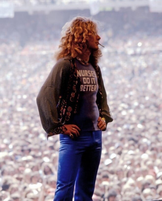 Robert Plant standing in front of a massive crowd at Oakland Coliseum, 1977