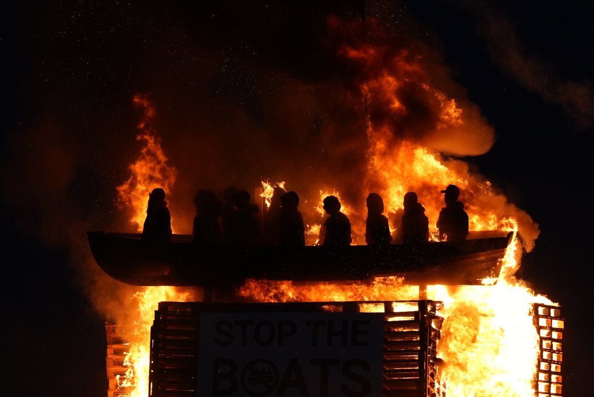 TimJ_B's tweet image. On the day the UK prime minister announced a small boats returns deal, an effigy of such a boat is being burned in on a bonfire in Northern Ireland
Pic: PA