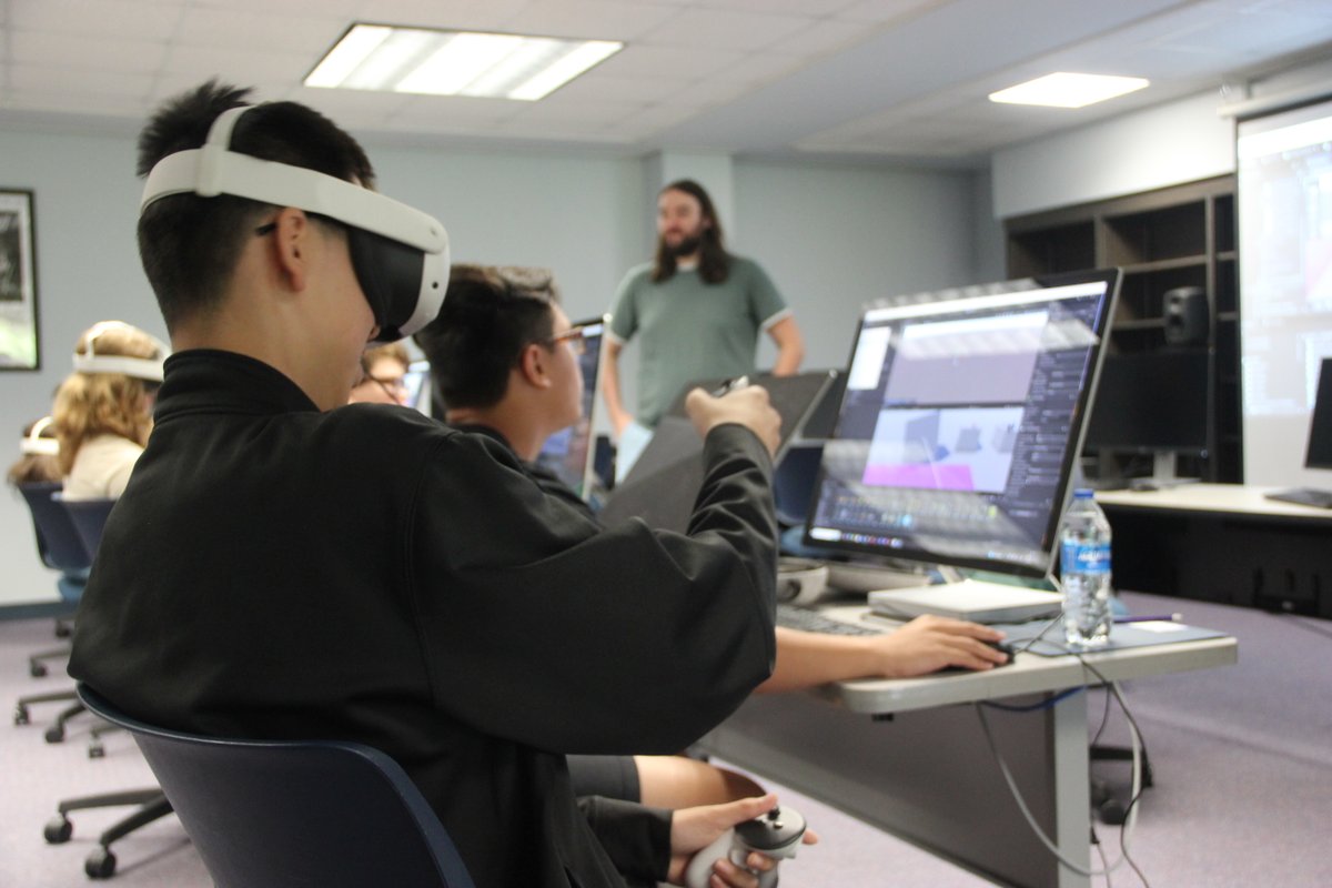 UofNO's tweet image. High school students in the BeyondReality@UNO summer camp are diving into virtual reality, learning 3D modeling, animation, and scripting to design their own VR games. Today, they explored their creations for the first time using VR headsets. 🕹🎮