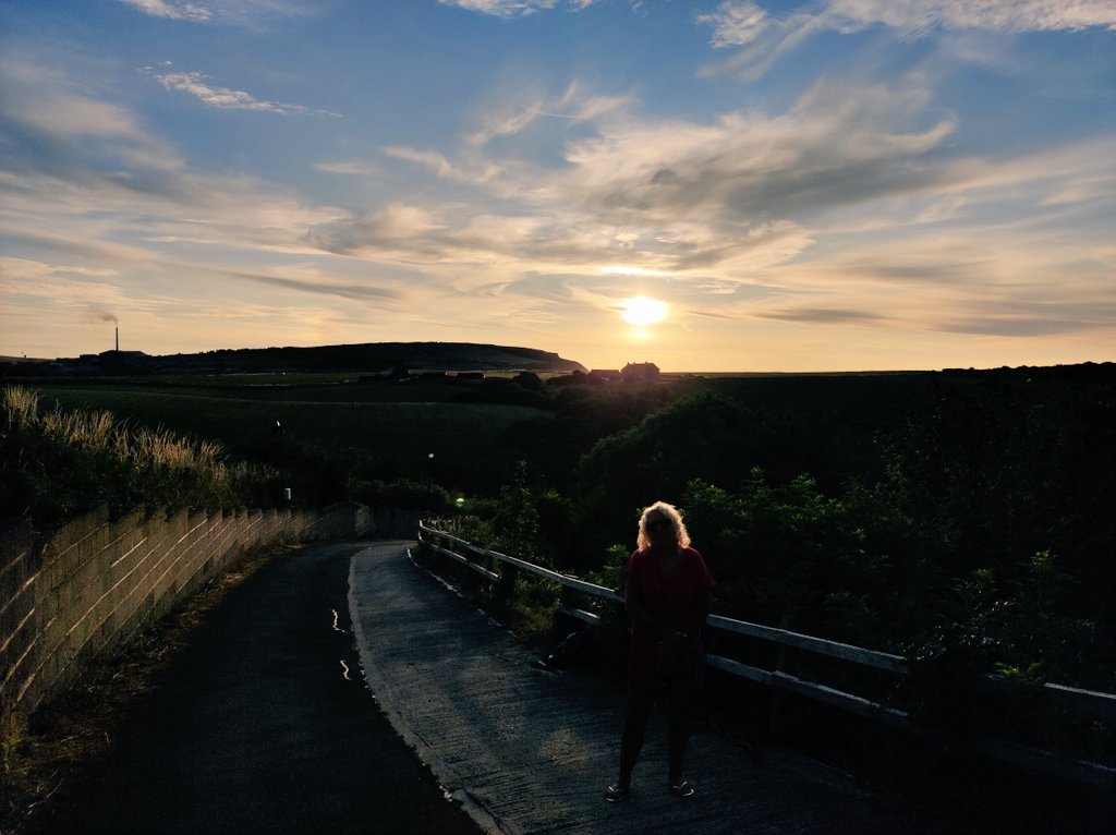 Sunset in Staithes with the outline of Tania's head just visible