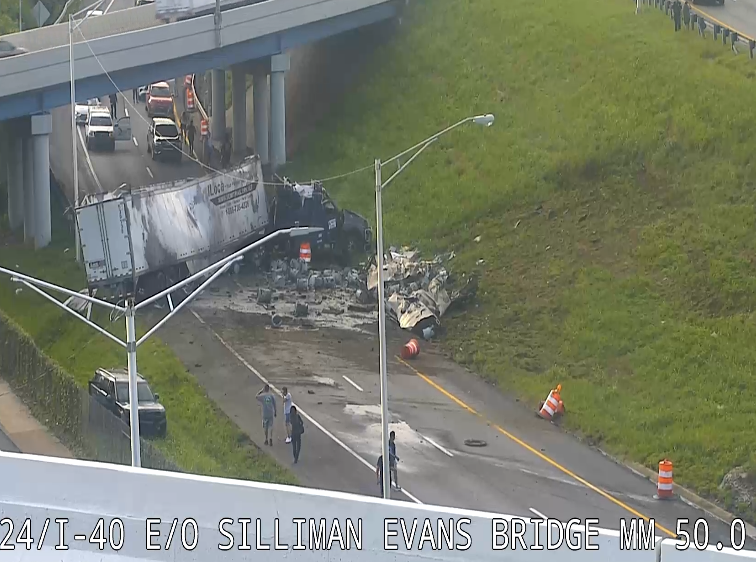 UPDATE: I-24 WB now open. The semi was traveling I-40 EB, left the roadway, down the embankment and landed on the WB lanes.