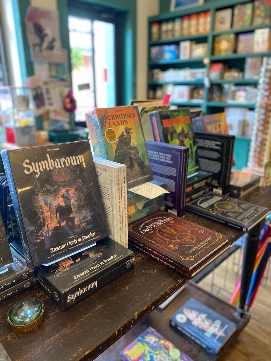 SquareBooks's tweet image. New games alert! We've got some more awesome game kits and companion books from Free League for y'all to choose your next adventure! New to our table are Symbaroum, a dark fantasy RPG, and Forbidden Lands, which is a SUPER fun sandbox survival RPG! #TabletopSummer #ShopIndie