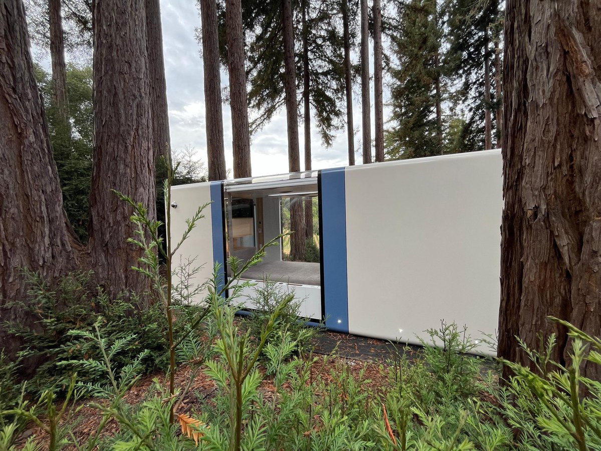 HausMicro's tweet photo. High-tech comfort in the heart of nature 🌲✨ #microhaus combines advanced systems, smart design, and sleek aesthetics all in one compact unit. Where would you place yours? #technology #smarthome #tinyhome #prefab #innovation #adu https://t.co/syPc0ZzDFX