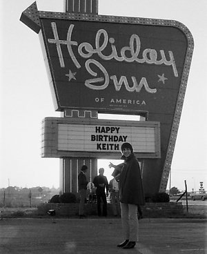 Keith Moon in front of a sign at a Holliday Inn in Flint, Michigan where he drove a Lincoln Continental into the pool, 1967
