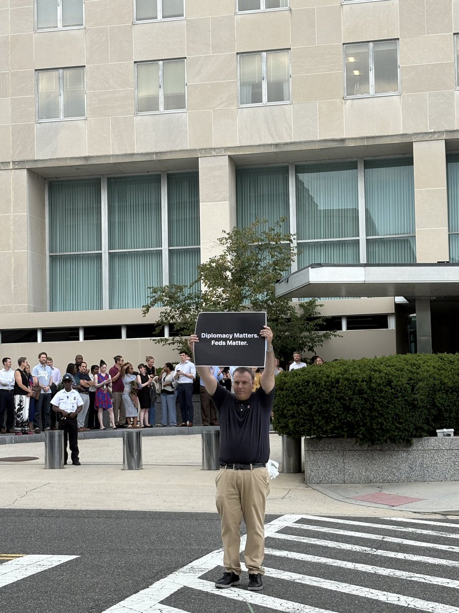 ebazaileimil's tweet image. Emotional scenes outside the State Department today as employees affected by a sweeping reduction in force leave the building. Current employees and supporters have lined up to “clap out” departing State Department staff at the department’s HQ in Foggy Bottom.